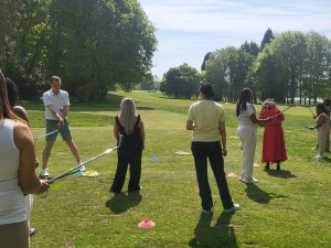 Golf professional showing Women how to grip golf club at Edgbaston Golf Club