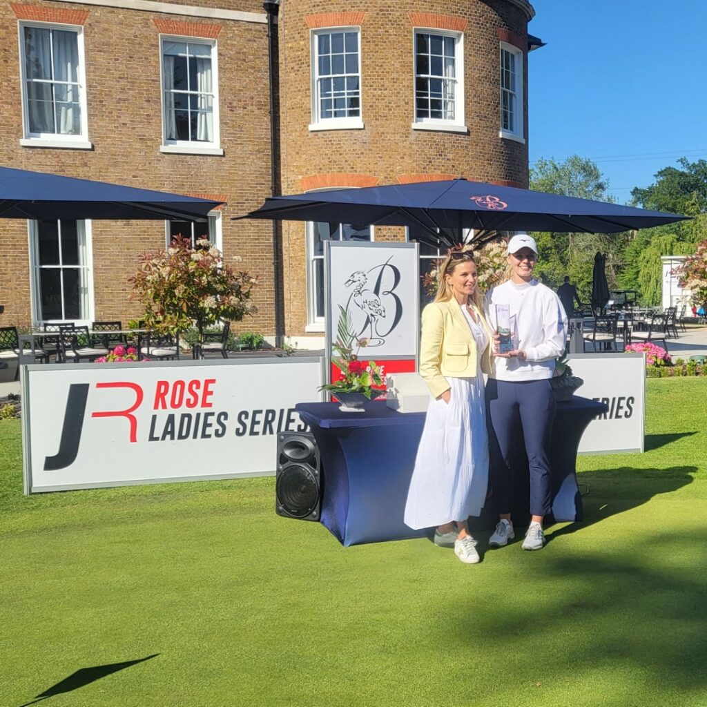 Hannah Screen receiving the Rose Ladies Series trophy from Kate Rose